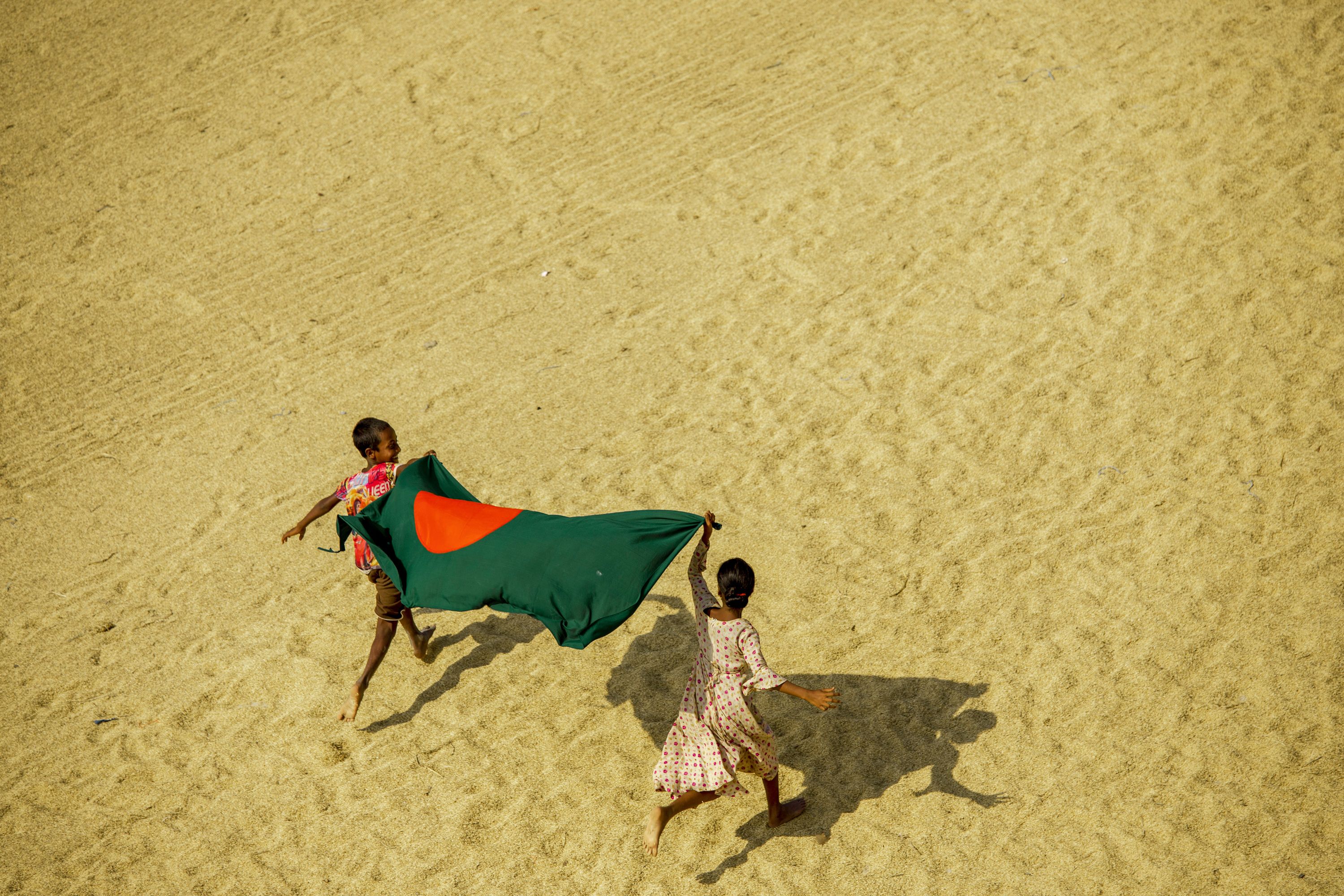 Children carrying the flag of Bangladesh